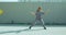Dancing child girl happy rhythmically moving against textured street fence. Energetic cool teen female dancer having fun