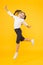 Dancing class. Small dancer moving to music on yellow background. Little child enjoy dancing to modern music. Energetic