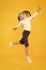 Dancing class. Small dancer moving to music on yellow background. Little child enjoy dancing to modern music. Energetic