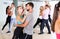 Dancing couples learning salsa at dance class