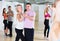 Dancing couples learning salsa at dance class