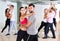 Dancing couples learning salsa at dance class