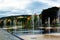 Dancing fountains square in Nice, France with vibrant houses, trees and bright blue sky