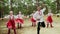 Dancing group are dancing Russian Traditional dances in summer forest