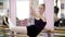 In dancing hall, Young ballerina in black leotard performs pirouette elegantly, standing near barre at mirror in ballet