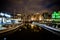 Dancing Houses and Boats at Damrak At Night in Amsterdam