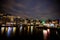 Dancing Houses and Boats at Damrak At Night in Amsterdam