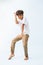 Dancing Indian boy showing his moves against bluish white background