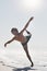 Dancing is just discovery. Full length shot of a handsome young man performing a challenging dance sequence on the beach