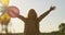 Dancing Little Girl with Colored Air Balloons in the Field Backlight