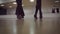 Dancing male and female legs in the dance studio