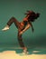 Dancing mixed race girl with afro hairs in colourful studio light. Female dancer performing expressive hip hop dance