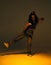 Dancing mixed race girl in studio spotlight. Female dancer performer show expressive hip hop dance