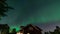 Dancing Northern lights Aurora borealis in autumn over northern horizon of Umea town, Sweden, night. Camera moving backwards