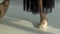 Dancing in pointe shoes on the tiptoes. Ballerina`s slender legs close-up. Slow motion.