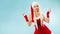 Dancing snow maiden. Charming and attractive blonde woman in a Santa suit.