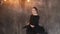 Dancing woman in black dress indoor