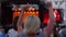 Dancing young girl in crowd of fans against backdrop of scene and bright flashing light close-up, Many fans at free rock