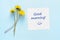 Dandelion flowers and paper with Good morning text