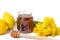 Dandelion honey in a jar and fresh flowers