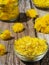 Dandelion inflorescences in a glass bowl close-up. Vintage wooden table. Dandelions as ingredients for making salad