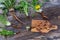 Dandelion root and whole plant on a wooden table. with root cut on cutting board with knife