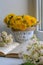 Dandelions in the bucket near a book