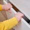 Danger for the baby to pinch the hand of the cabinet door or chest of drawers. Protect children from home furniture, kids safety