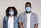 Danger Of Coronavirus. Scared black couple posing in protective medical masks