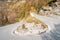 Danger curve on serpentine mountain road, picturesque Alps autumn landscape. Lombardy, Italy.