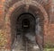 Danger Dark brick tunnel of the catacomb with arched entrance view to the darkness