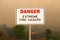 Danger Extreme Fire HazardSign with Wildfire Background