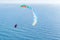 Danger extreme flying tandem paraglider over the sea