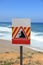 Danger falling rocks sign near a beach