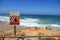 Danger falling rocks sign near a beach