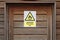 Danger flammable gas warning caution sign on wooden door