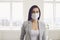 Danger of infection of the virus coronavirus infection. Businesswoman in medical mask at office