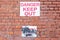 Danger keep out and warning anti vandal paint sign on brick wall of derelict building birkenhead wirral september 2019