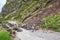 Danger mountain landslide stone slope threaten to block road for driver and resident of the city.