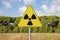 Danger of radioactive contamination from RADON GAS - concept with warning symbol of radioactivity on road sign against a building