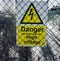 Danger sign - High voltage behind the grid.