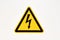 Danger sign of high voltage electricity. Yellow triangular mesh with a zipper in the center