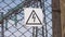 The danger sign of high voltage on the fence of the power plant. Risk of electric shock. Power generators, electricity
