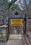 Danger sign and iron gate blocking nature trail