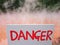 Danger signage with fog in the background