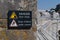 Danger sudden drop sign yellow warning triangle with symbol of man falling from a cliff edge and keep children under control sign