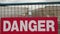 danger writing caption text sign in white capital letter on red background