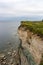 Dangerous cliff edge with the yellow flower meadow