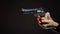 Dangerous contract killer aiming gun isolated on black background, crime