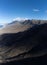 Dangerous dirty road to golden sandy Cofete beach hidden behind mountain range on Fuerteventura, Canary islands, Spain, aerial